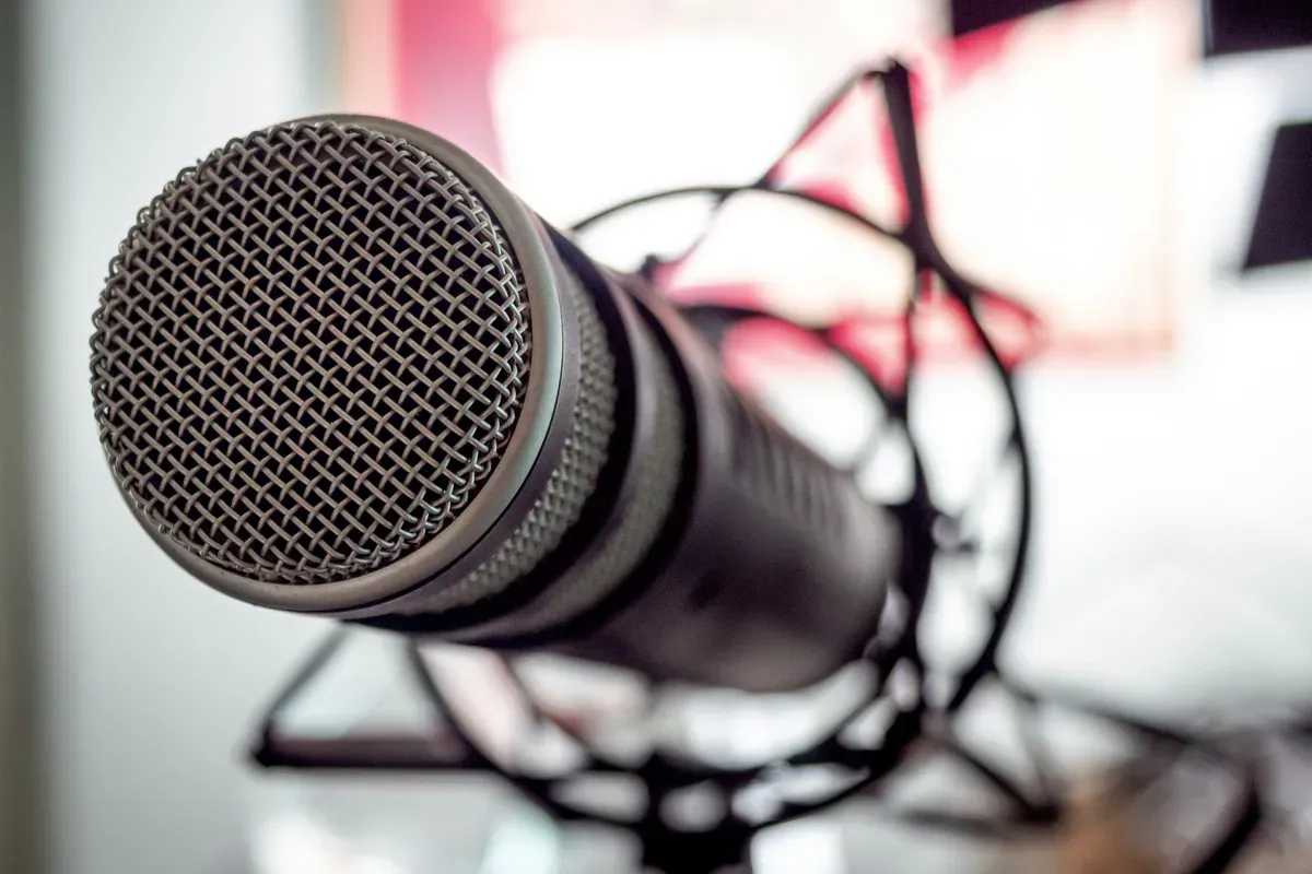 A black microphone lying on a white table