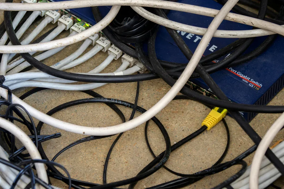 A tangle of network cables with everything plugged into everything