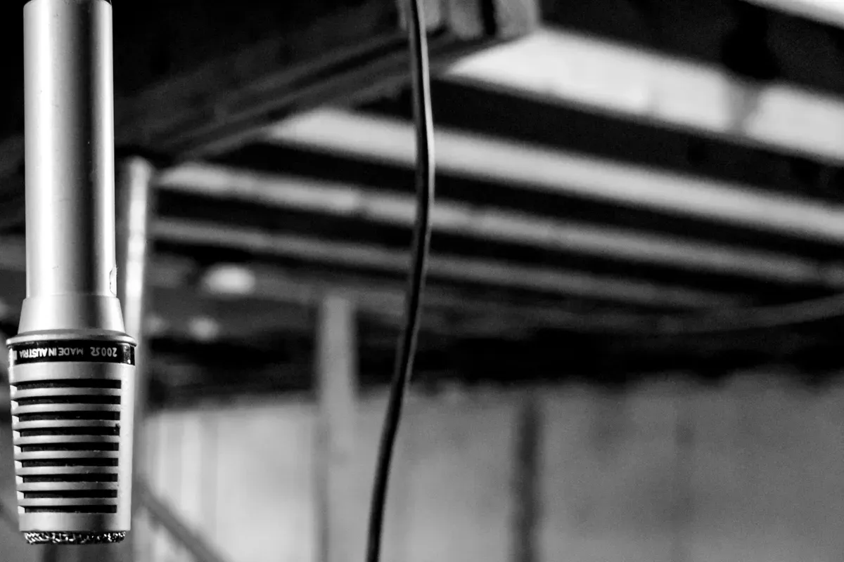 A single black coated cable coiled on a plain ground
