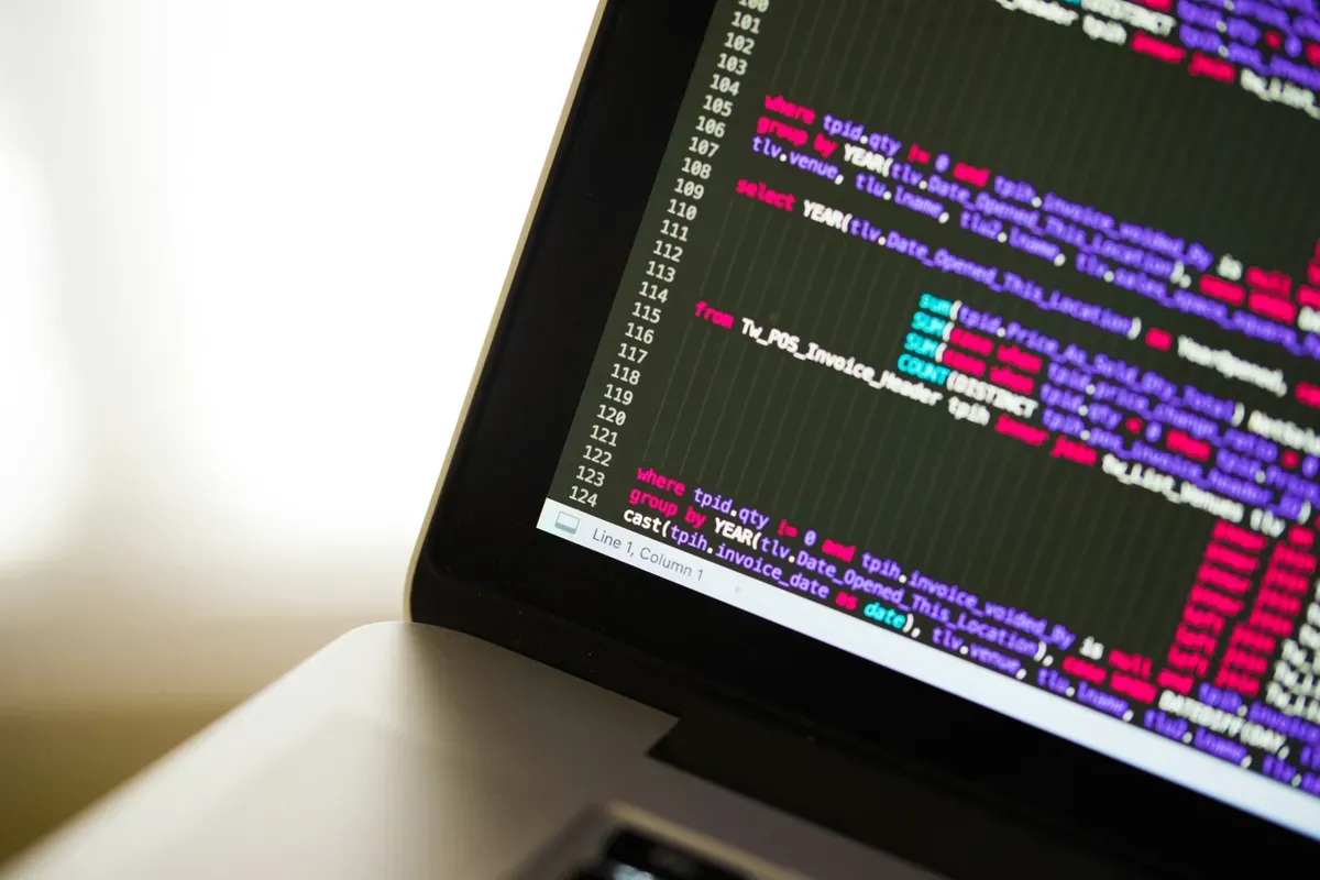 A laptop screen showing a block of source code mid-update