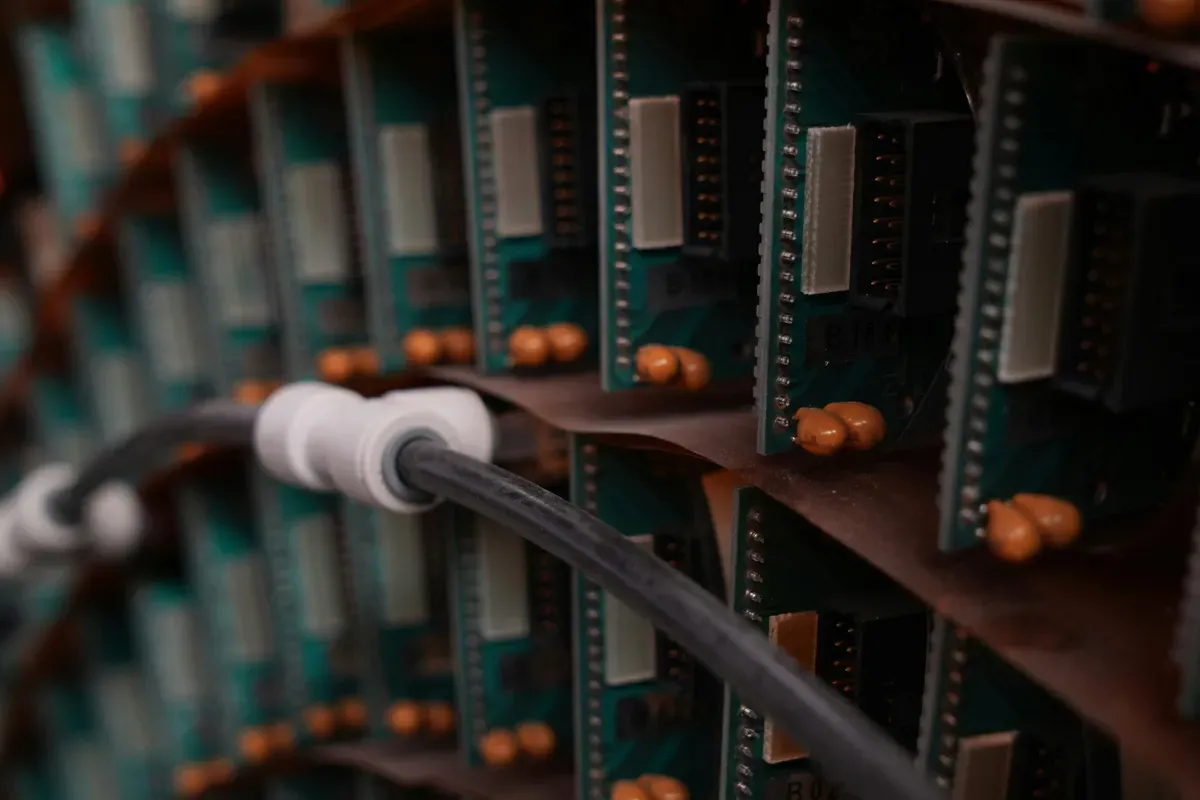 Rows of circuit boards with chips and a ribbon cable running between them