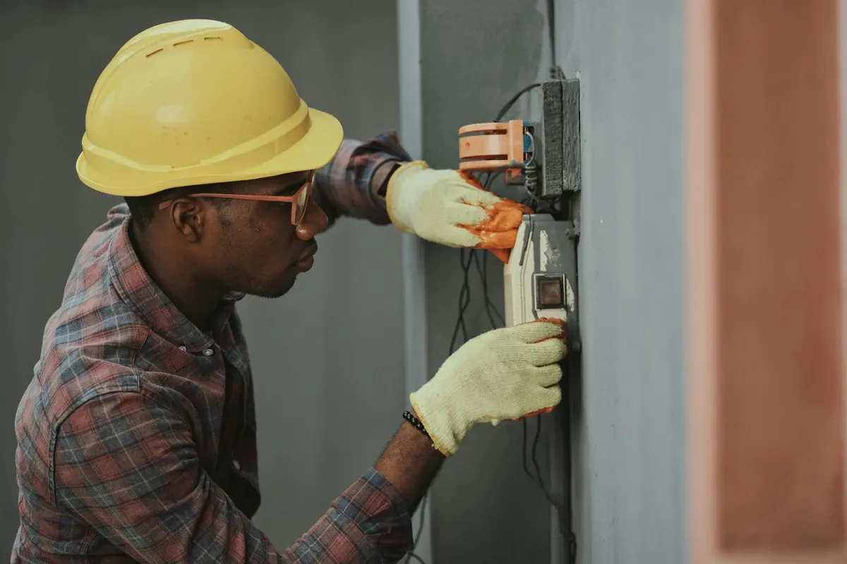 An electrician installing wiring where the controller ends up living