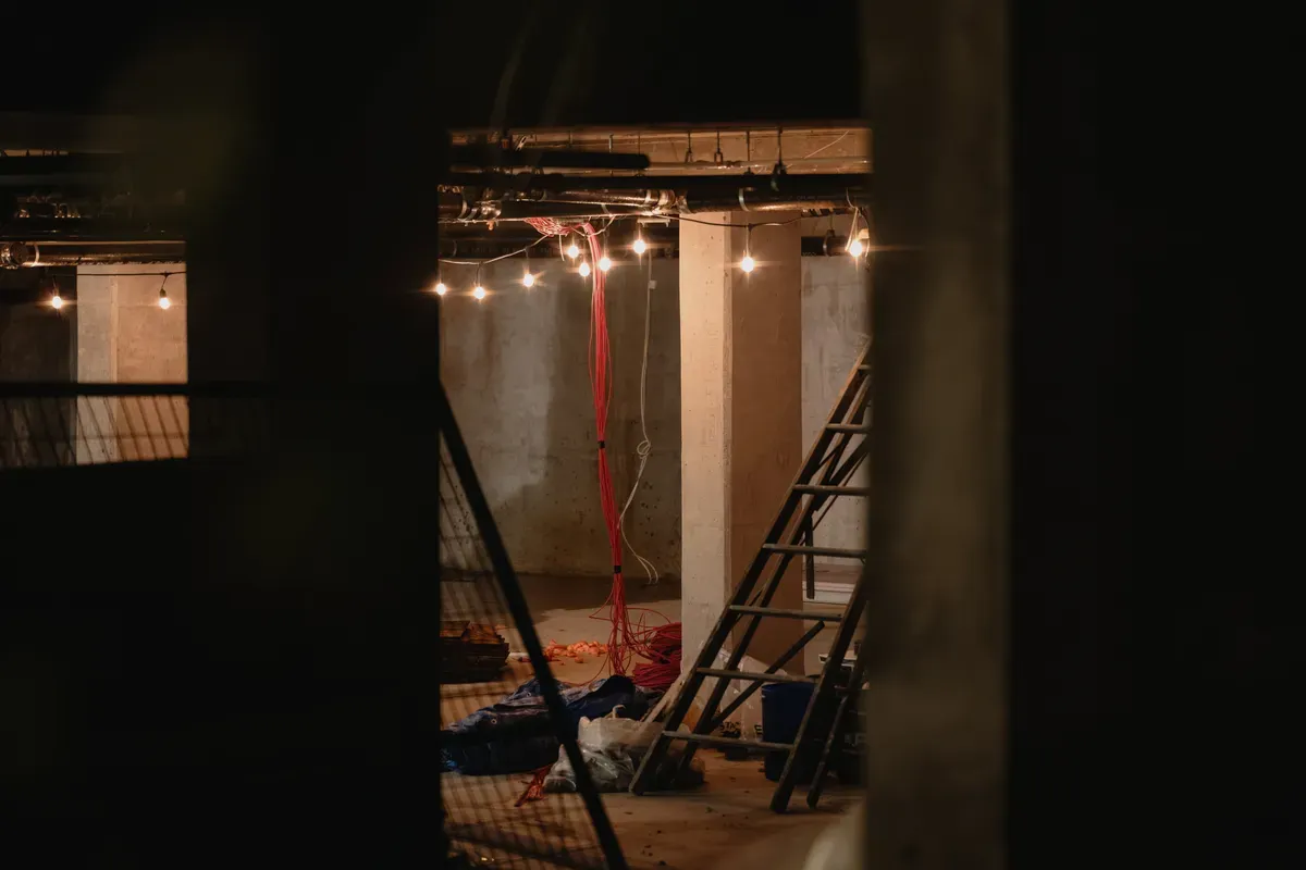 A construction site with ladders and loose cables hanging before any wall is closed