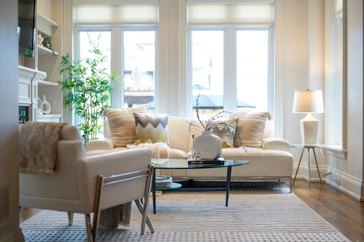 A bright living room with a sofa and an armchair