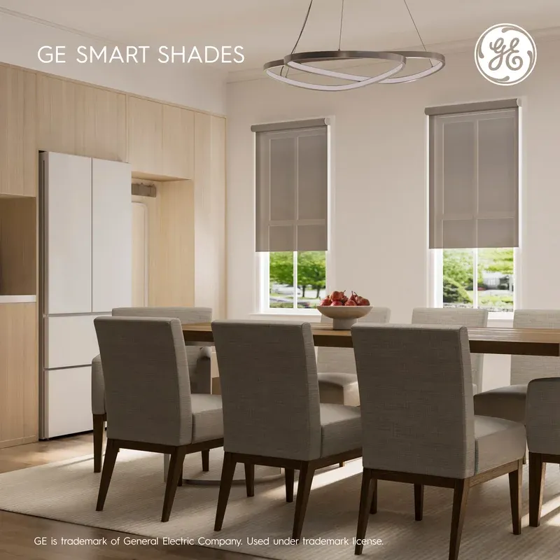GE Smart Shade motorized roller installed on two windows in a modern dining room