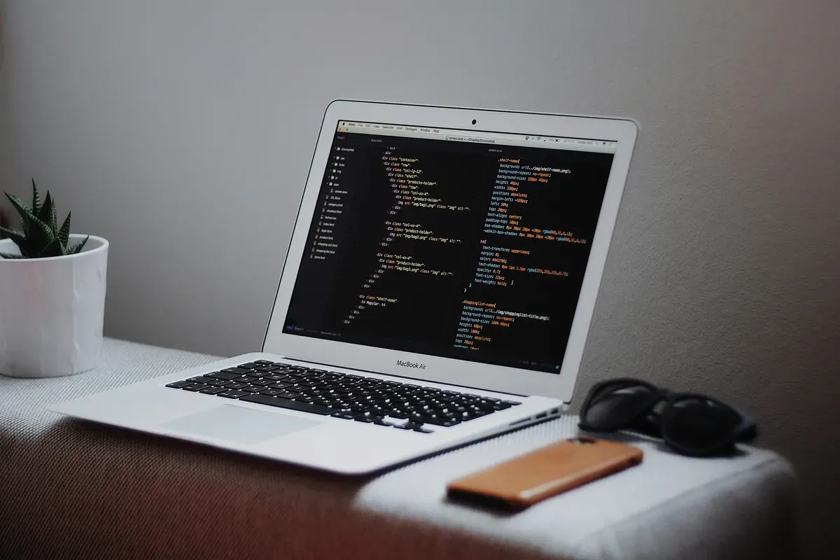 A laptop open on a desk with a long list on screen