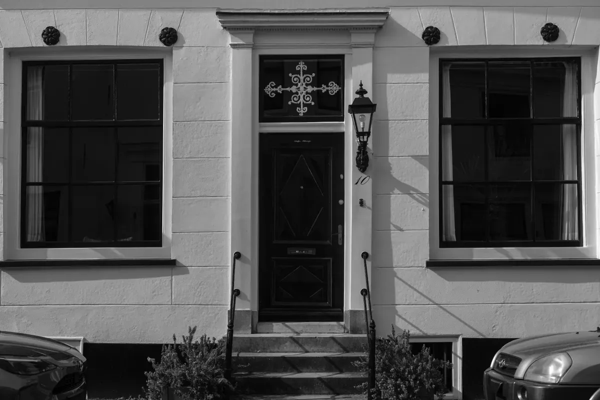 The facade of a house seen from the street, the view from the car