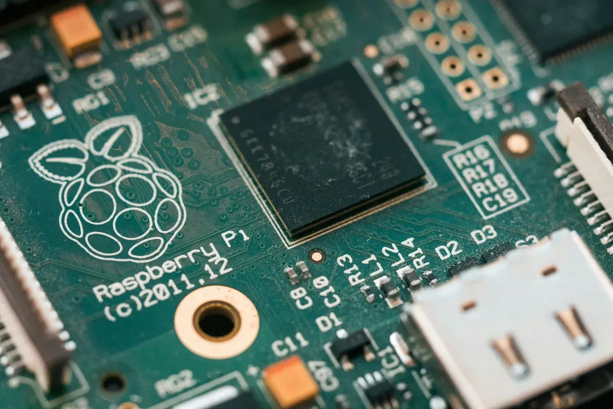 A green circuit board photographed close up, card slot included