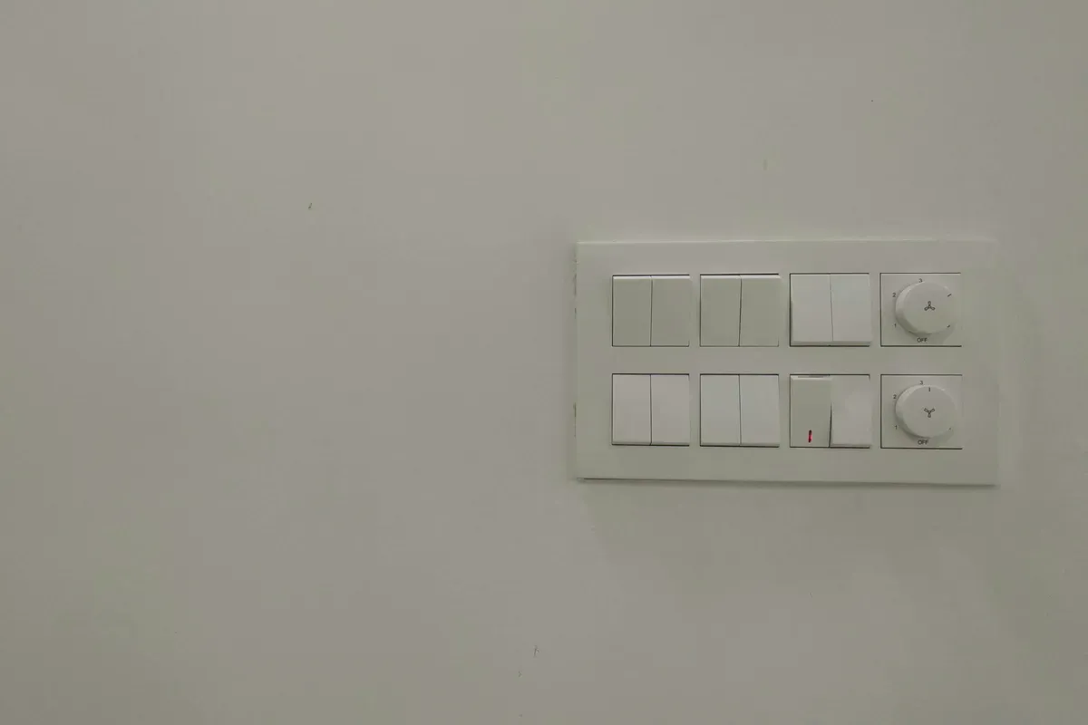 A white wall-mounted device on a white painted wall