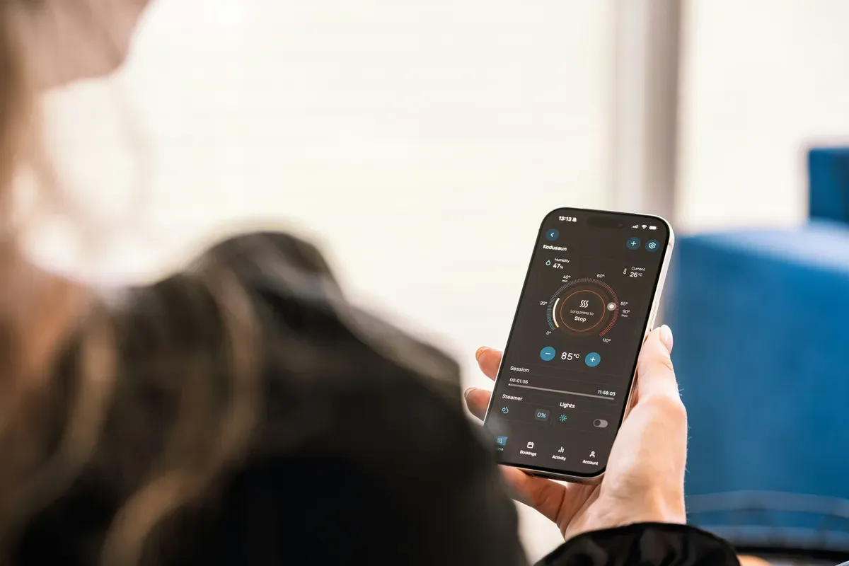 A person holding a smartphone showing a single app screen