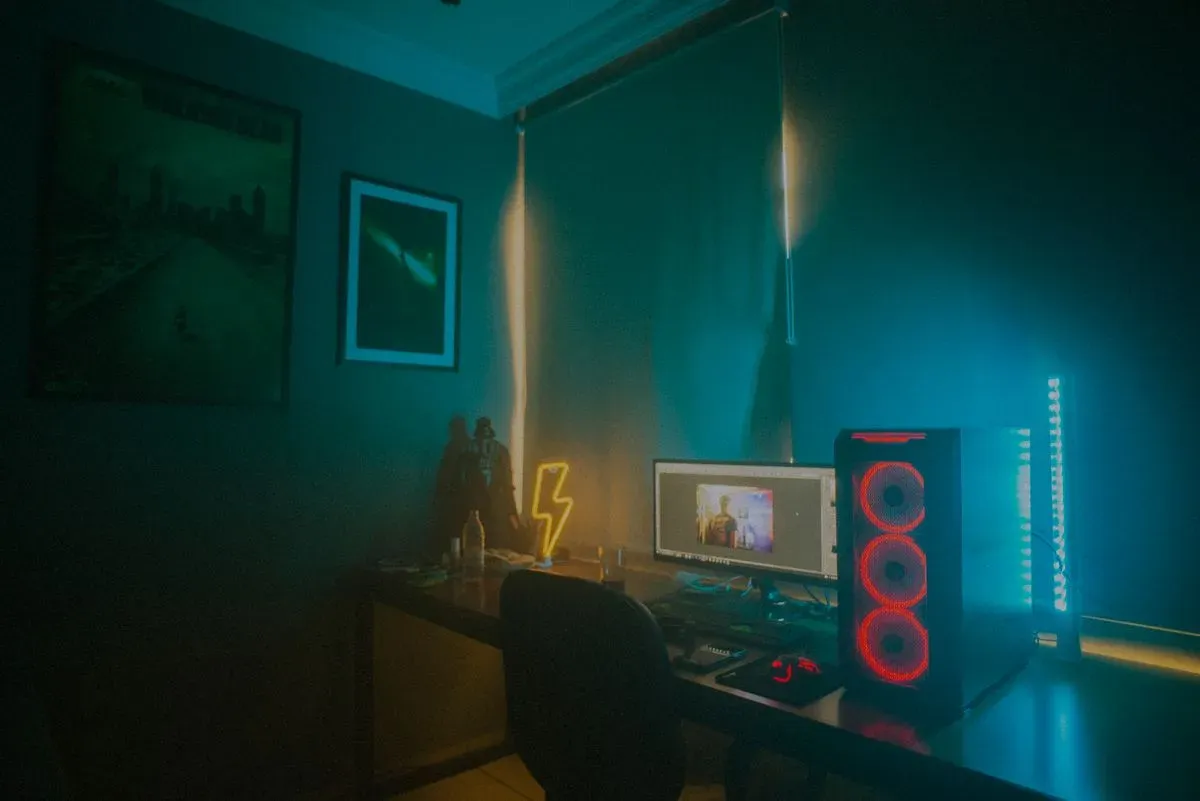 Minimalist room glowing with colored smart LED ambient lighting at night