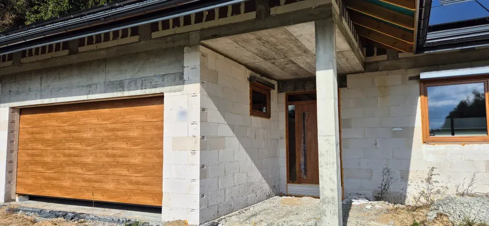 Front of the house showing the garage door and the covered entrance, with the wall the garage switch sits behind