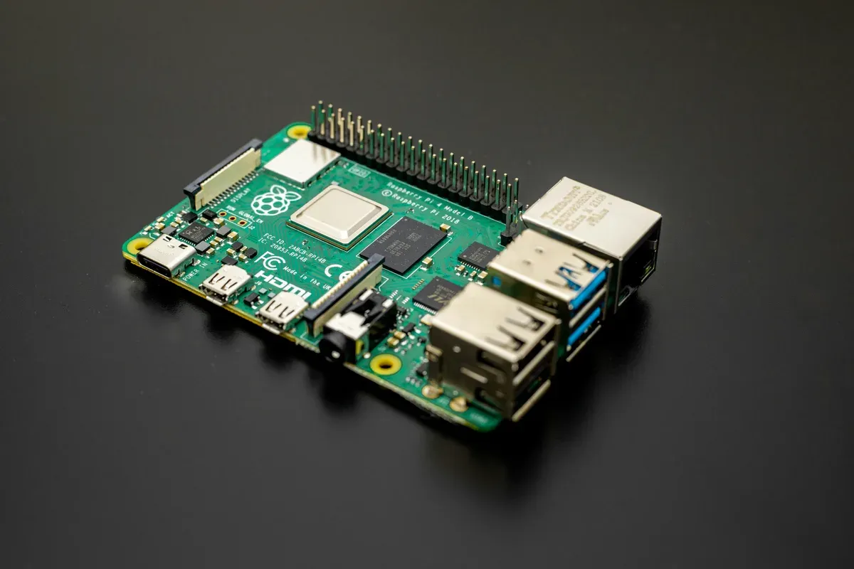 A Raspberry Pi single-board computer on a dark surface, the class of hardware an OpenThread Border Router add-on runs on