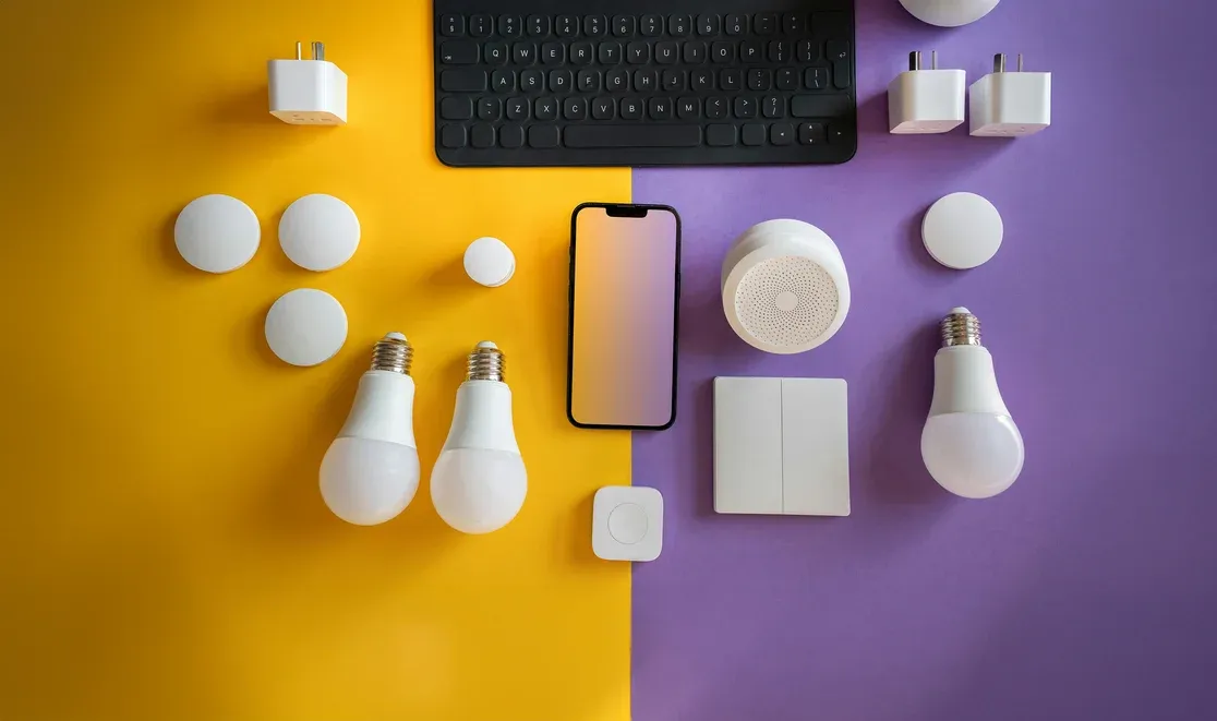 collection of smart home devices including bulbs, sensors, plugs, and a phone