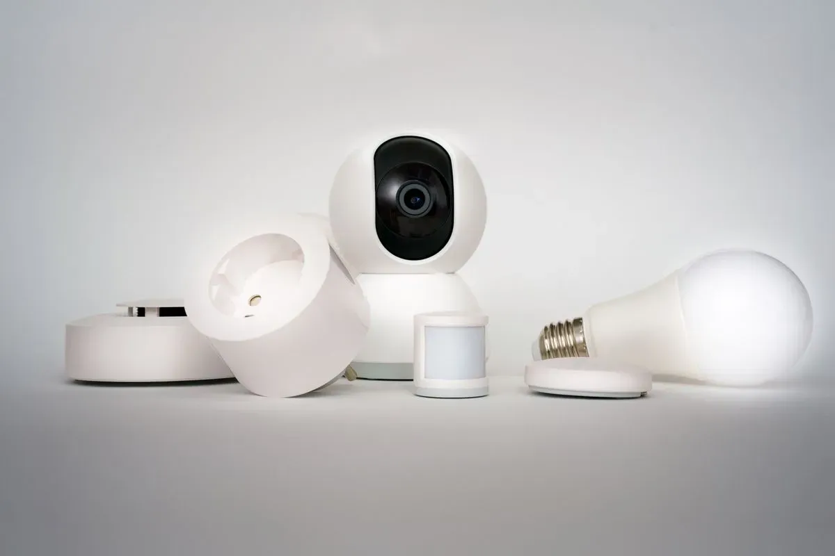 Connected smart home devices including a camera and lightbulb in a minimalist setup