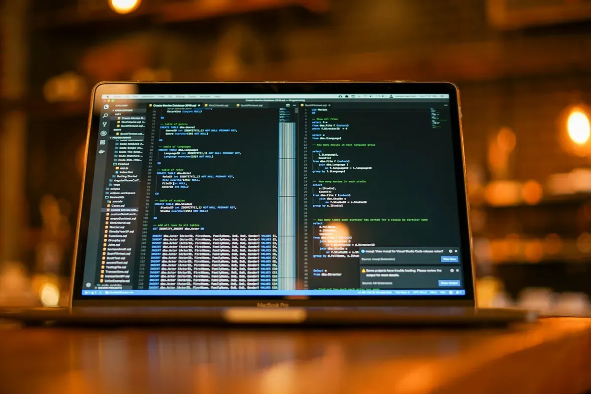 A wide monitor showing output in a dim room