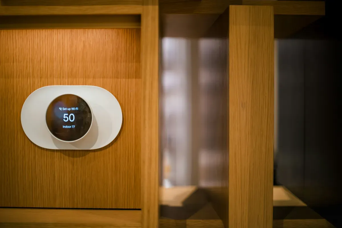 A round wall dial in a room with wood panelling