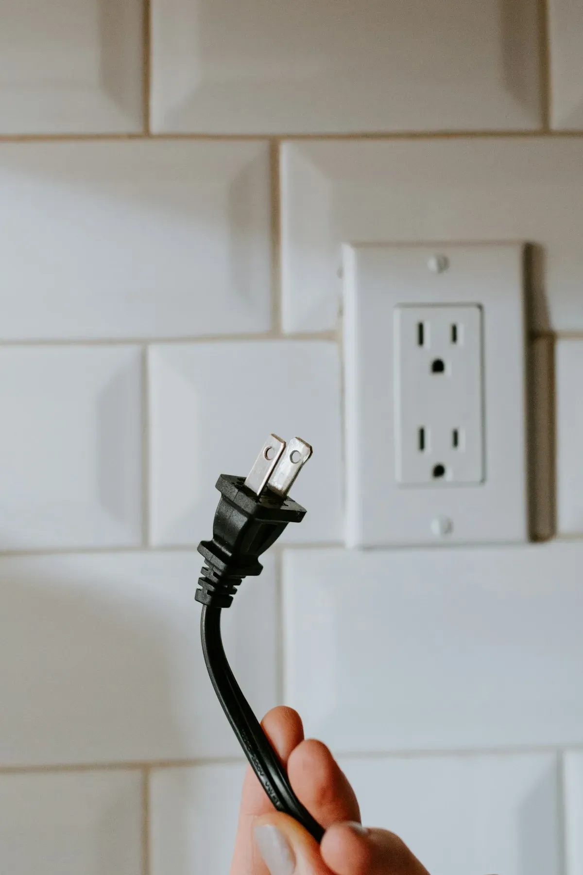 A device plugged into a white wall outlet at home