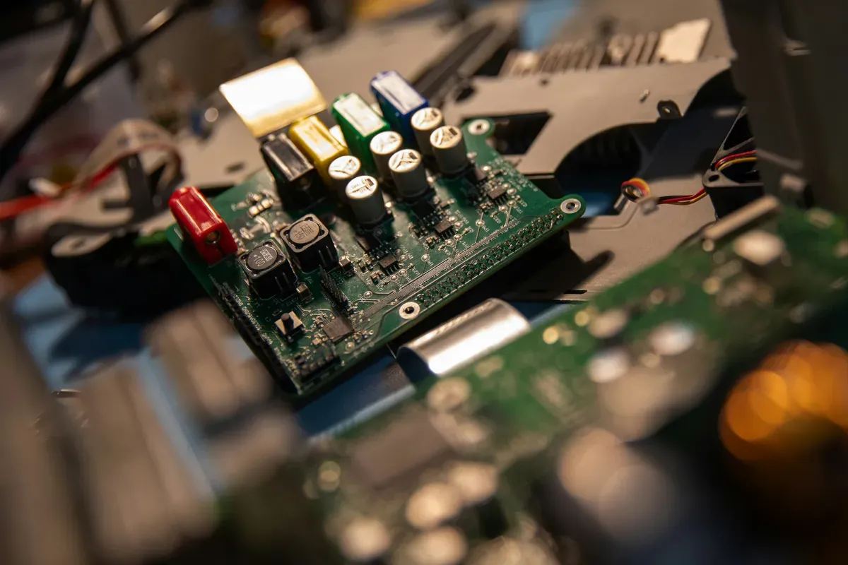 A computer motherboard with many wires attached
