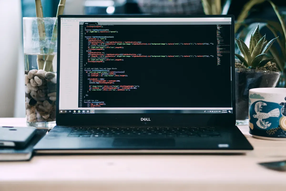 A laptop on a desk lit only by its own screen during an install