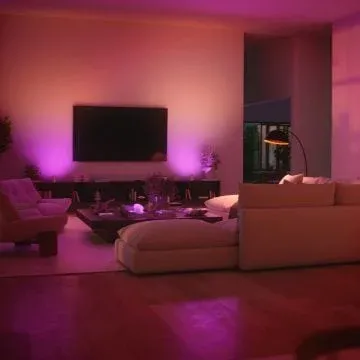 Modern living room with soft ambient purple Philips Hue lighting showing Spatial Scenes effect