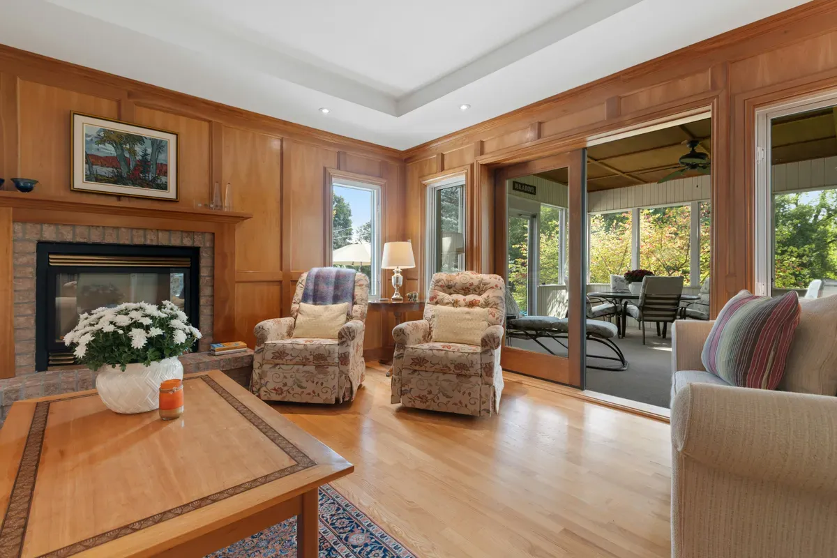 A furnished living room with a fireplace at one end