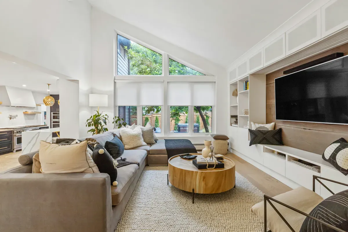 A furnished living room with a sofa facing a wall unit