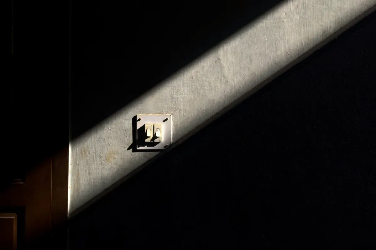 Sunlight falling across a wall switch, the control every room already has
