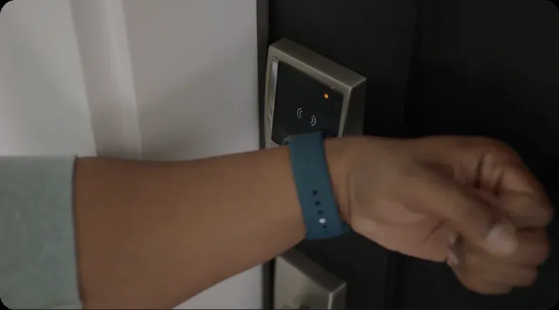 Woman using Apple Watch to unlock a Schlage Encode Plus via NFC tap