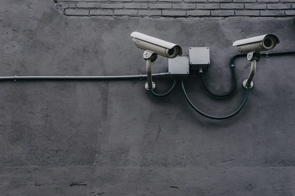 Two bullet cameras bolted to an outside wall