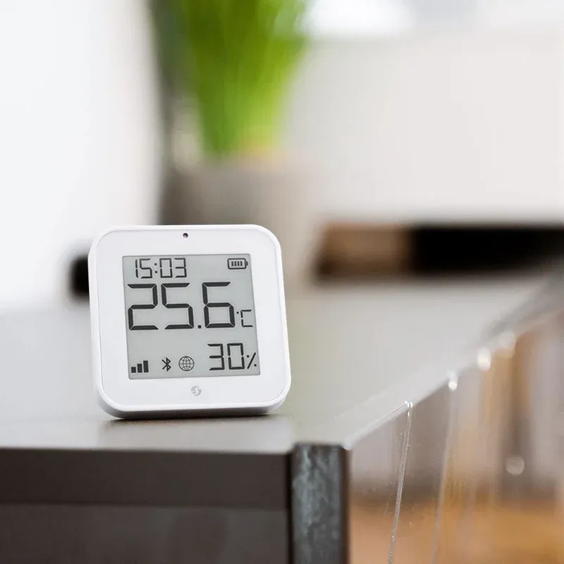 Shelly Smart Display E-Paper white model mounted on a wall in a living space