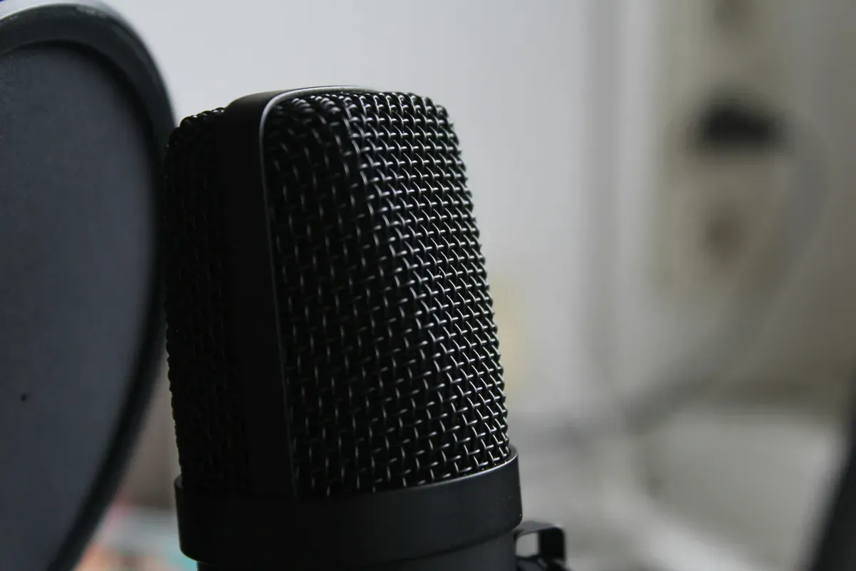 A black microphone resting on a white table