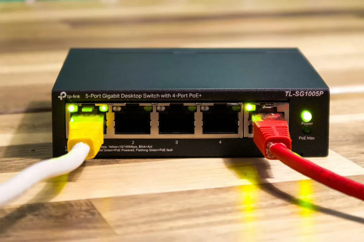 A small network switch with cables plugged into its ports