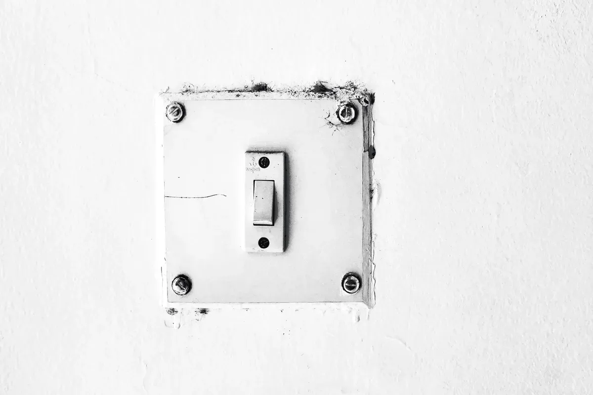 A plain white light switch shot close