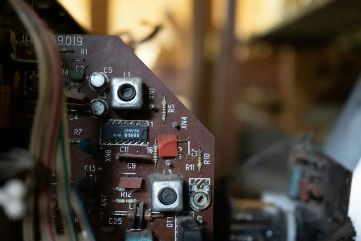 An old circuit board with its components still fitted