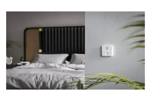 TUO Smart Button mounted on the wall near a light switch TUO Smart Button in lifestyle setting
